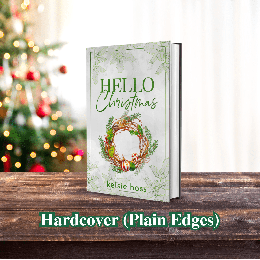 a book, "Hello Christmas" sits upright on a table, in front of a christmas tree.
Hardcover (Plain Edges)
