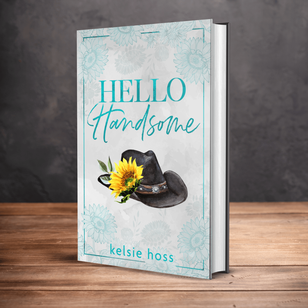 a book "Hello Handsome sits upright on a table