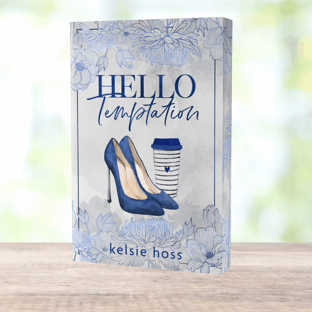 a paperback copy of Hello Temptation by Kelsie Hoss, the cover features a pair of heels and a travel cup of coffee 