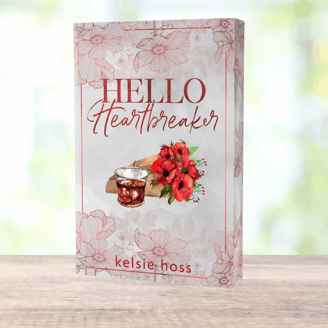 a paperback copy of Hello Heartbreaker by Kelsie Hoss, the cover features a bouquet of roses 