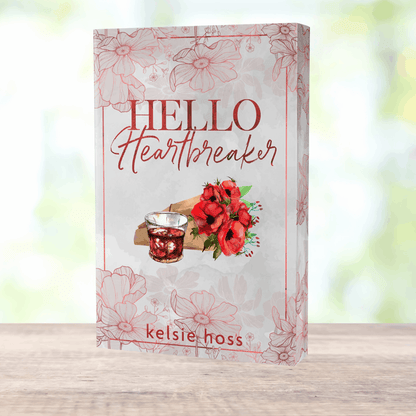 a paperback copy of Hello Heartbreaker by Kelsie Hoss, the cover features a bouquet of roses 