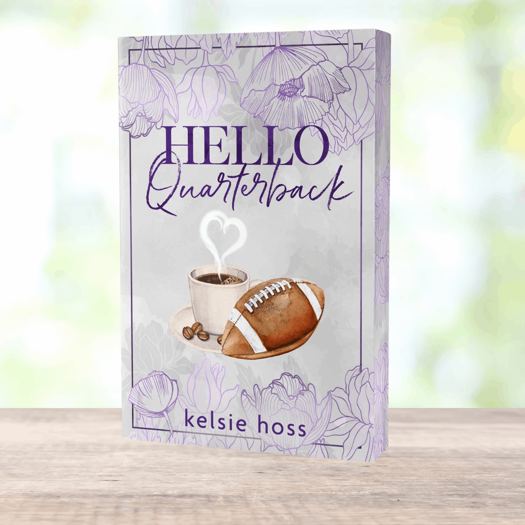 a paperback copy of Hello Quarterback by Kelsie Hoss, the cover features a football and a cup of cocoa 
