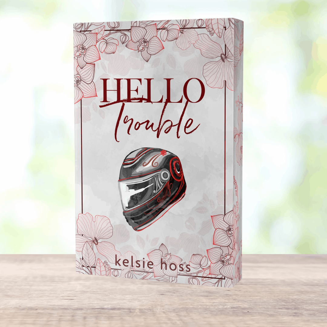 a paperback copy of Hello Trouble by Kelsie Hoss, the cover features a motorcycle helmet 