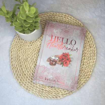 "Hello Heartbreaker" sits on a mat next to a succulent 