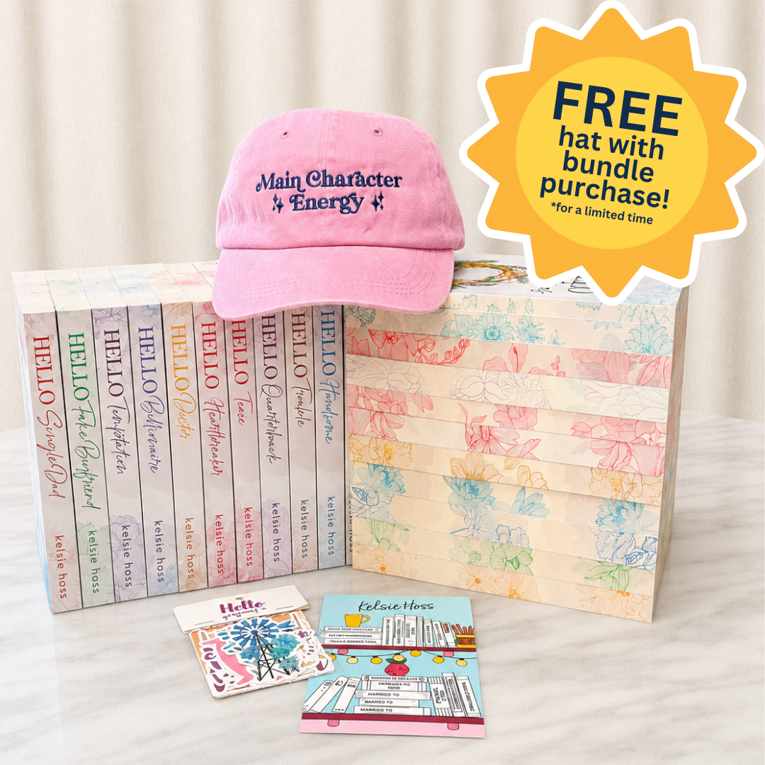 Pink cap with "Main Character Energy" text, Hello Series books, and stationery items on a white surface with a free hat offer label.