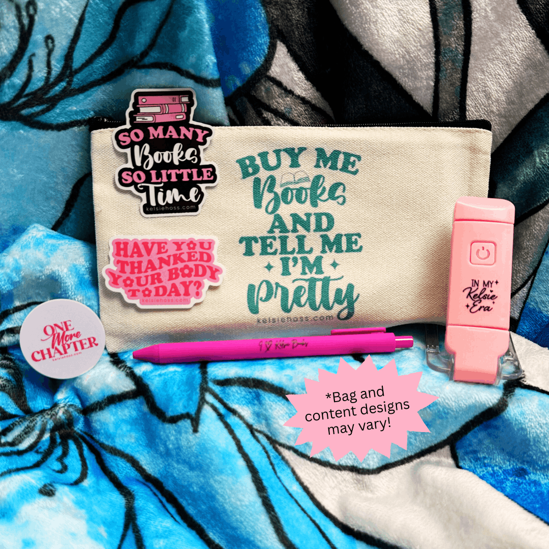 Cosmetic bag with motivational text, pink pen, two stickers, a popsocket, and pink book light on a blue and gray patterned background. Note, bag and content designs may vary.
